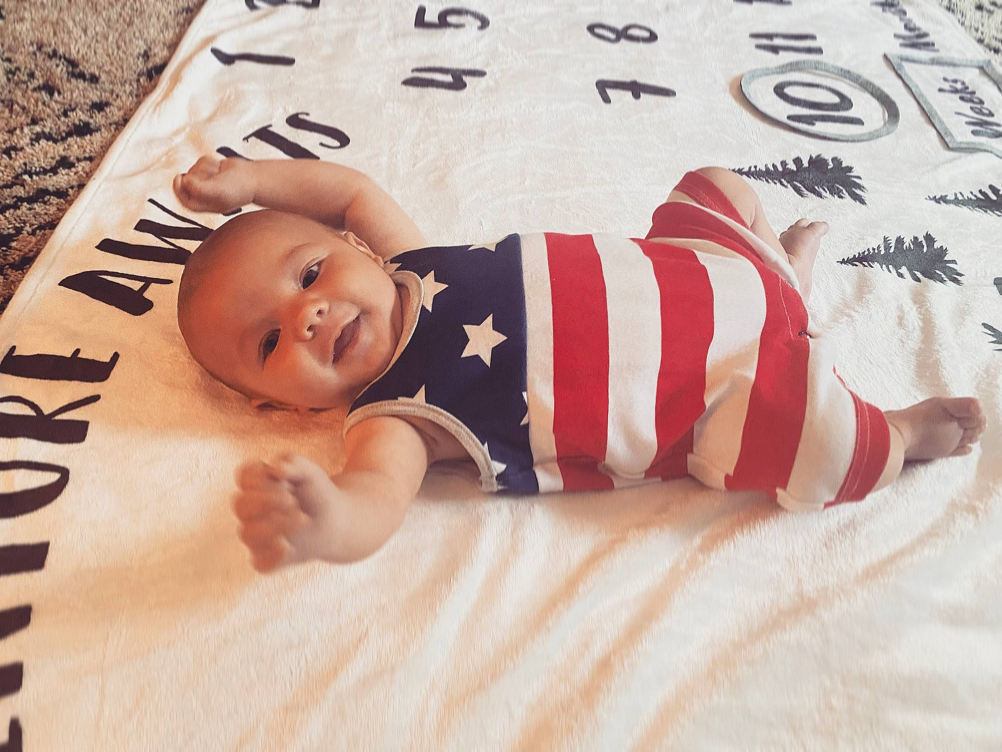 Avery joined the competition — help win amazing prizes! art, baby, baby_sleeping, baby_toddler_clothing, bedding, carmine, comfort, finger, flag_of_the_united_states, flooring, font, happy, illustration, linens, pattern, person, sleeve, smile, textile, toddler