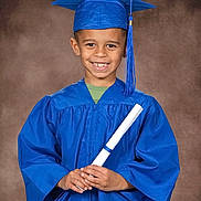 Karsyn is registered to the contest to win money with this photo: child, boy, graduation, cap, gown, diploma, smile, portrait, studio, celebration, achievement, education, young, happy, person, blue, clothing, background, pose, tassel