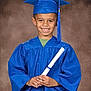 child, boy, graduation, cap, gown, diploma, smile, portrait, studio, celebration, achievement, education, young, happy, person, blue, clothing, background, pose, tassel