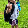 Aleigha joined the competition — help win amazing prizes! child, girl, smiling, outdoor, grass, backpack, water_bottle, purple_bow, sporty_clothing, shorts, sneakers, peace_sign, happy, greenery, summer, casual, youth, nature, standing, portrait
