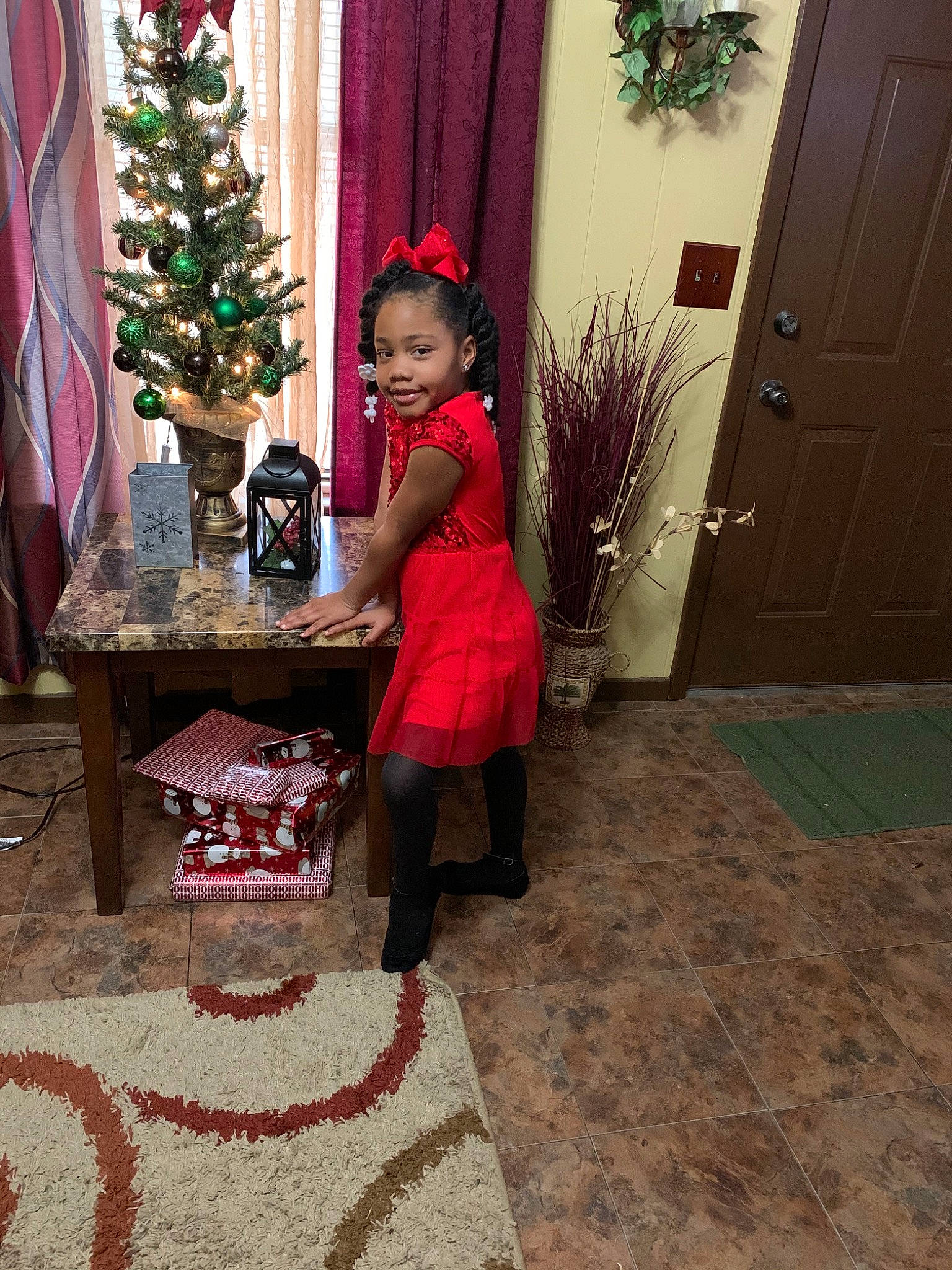 Joi is registered to the contest to win money with this photo: child, christmas, christmas_decoration, christmas_eve, christmas_ornament, christmas_tree, event, floor, flooring, holiday, home, interior_design, joy, person, room, toddler, tree