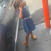 Janacia joined the competition — help win amazing prizes! child, girl, sunglasses, braids, hair_beads, denim_dress, dress, sandals, standing, posing, outdoor, parking_lot, car, vehicle, orange_bollard, sidewalk, driveway, sunlight, fashion, portrait