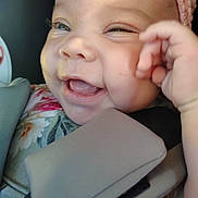 Mariah is registered to the contest to win money with this photo: baby, child, smiling, headband, car_seat, closeup, face, joyful, happy, infant, padded_strap, cute, skin, hand, mouth, teeth, clothing, seatbelt, person, portrait