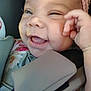 baby, child, smiling, headband, car_seat, closeup, face, joyful, happy, infant, padded_strap, cute, skin, hand, mouth, teeth, clothing, seatbelt, person, portrait