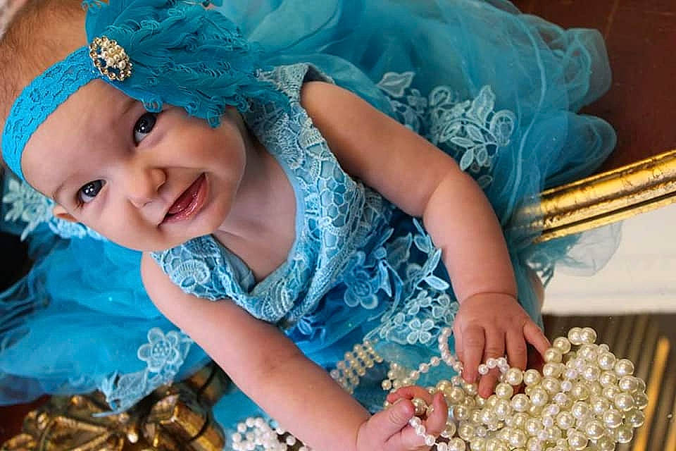 Eevee is registered to the contest to win money with this photo: aqua, blue, child, costume, fashion_accessory, hair_accessory, headband, headgear, headpiece, jewellery, person, smile, toddler, turquoise