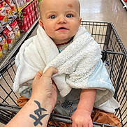 Cullen joined the competition — help win amazing prizes! baby, shopping_cart, blanket, grocery_store, aisle, snacks, hand, tattoo, blue_eyes, infant, clothing, floor, person, holding, cute, portrait, shopping, child, cart, wrapped