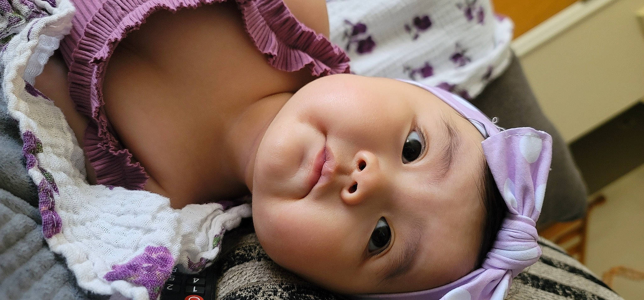 Celeste joined the competition — help win amazing prizes! baby, baby_toddler_clothing, cheek, child, eye, eyebrow, eyelash, face, facial_expression, happy, head, headgear, headwear, lip, mouth, nose, person, pink, purple, skin