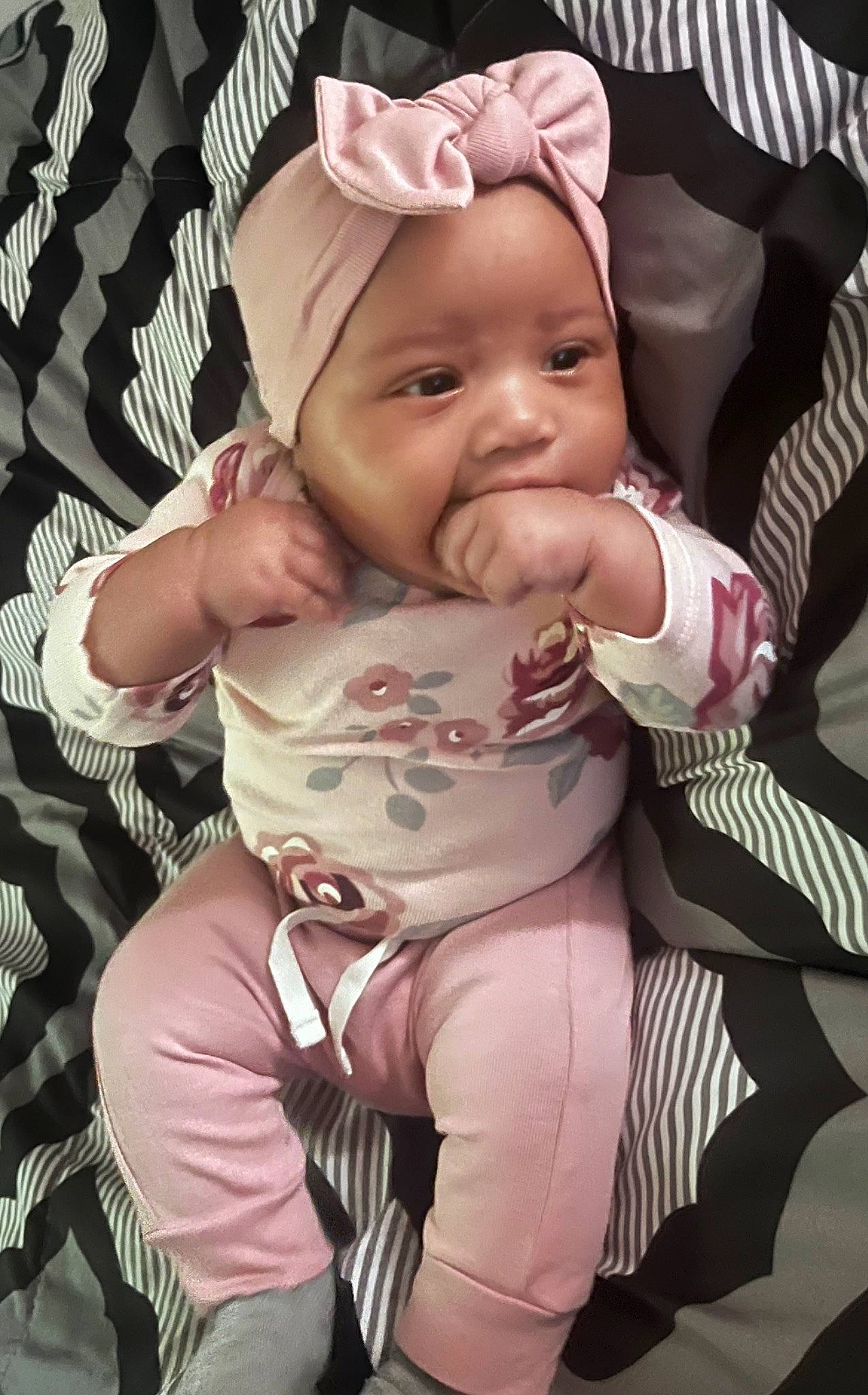 Amora is registered to the contest to win money with this photo: baby, baby_carriage, baby_products, baby_toddler_clothing, cheek, child, comfort, event, fun, gesture, happy, headwear, lap, pattern, person, pink, sitting, skin, sleeve, smile