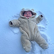 Owen joined the competition — help win amazing prizes! child, baby, infant, snow, winter, snowsuit, onesie, hood, bear_ears, outdoor, lying_down, snow_angel, smile, rosy_cheeks, cozy, warm_clothing, footprints, white_background, cold, cute