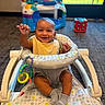 Zayden joined the competition — help win amazing prizes! baby, baby_walker, smiling, indoor, toy, socks, child, happy, person, carpet, play_area, colorful, seat, waving, infant, window, floor, plastic, bib, furniture