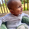 Zayden is registered to the contest to win money with this photo: baby, child, smiling, pajamas, star_pattern, green_cushion, porch, wooden_deck, outdoor, daylight, face, head, person, infant, happy, seated, nature, trees, sky, cute
