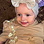 baby, infant, headband, bow, dress, beige, smiling, tongue, face, cute, child, young, stain, fabric, soft, clothing, sitting, person, portrait, indoors