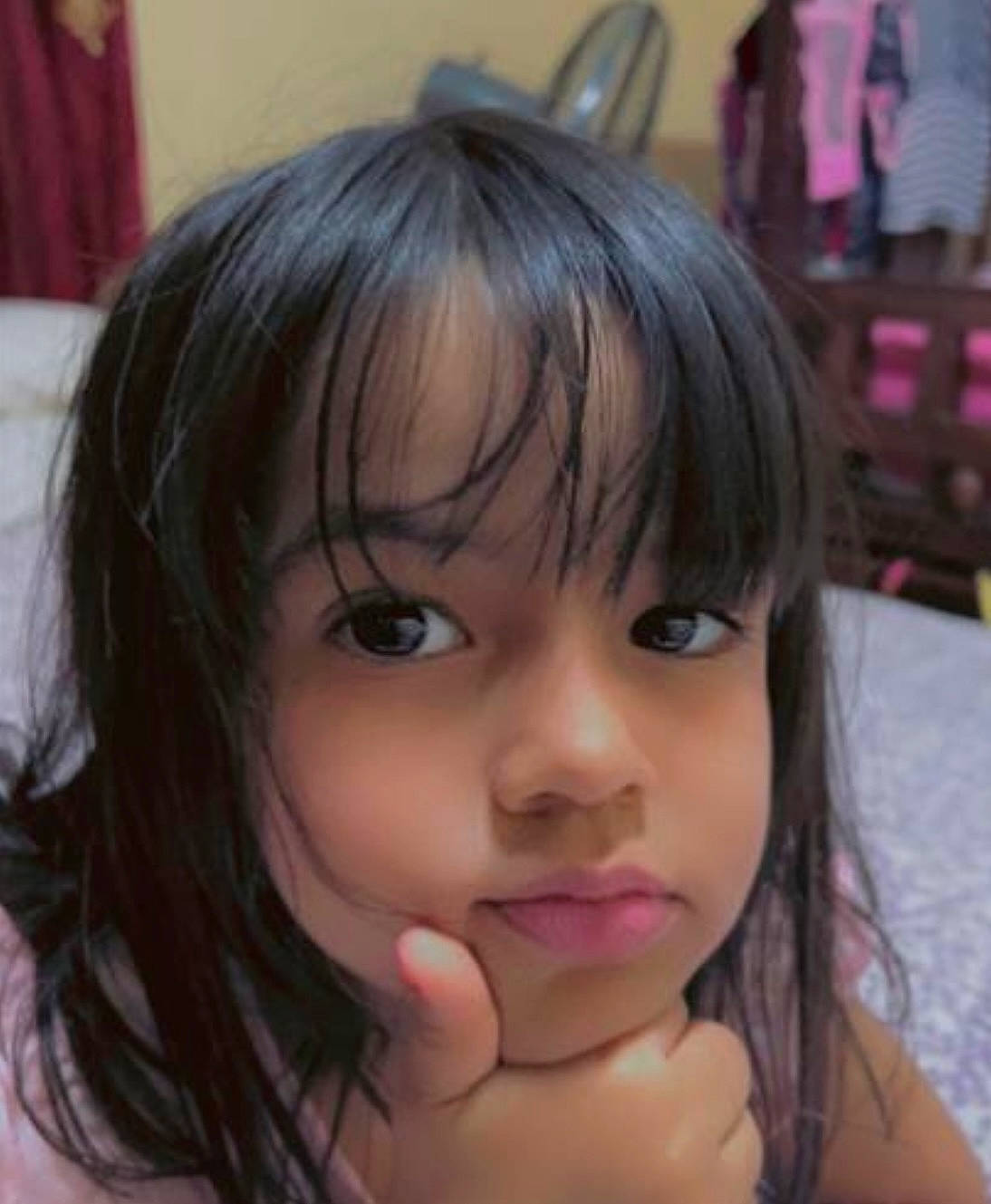 Isabella is registered to the contest to win money with this photo: bangs, black_hair, cheek, ear, eyebrow, eyelash, facial_expression, forehead, gesture, hairstyle, happy, iris, jaw, layered_hair, lip, mouth, neck, nose, person, pink