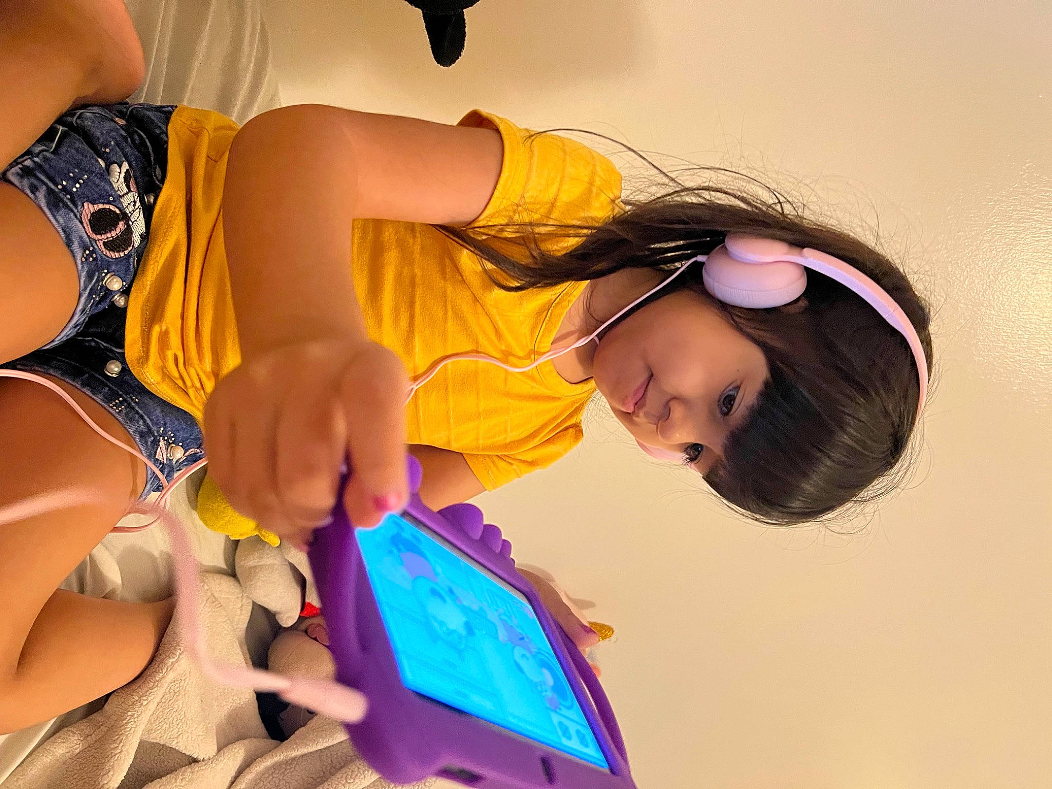 Isabella is registered to the contest to win money with this photo: black_hair, child, communication_device, cool, electric_blue, eyewear, finger, fun, hand, happy, human_body, human_leg, leisure, magenta, mobile_phone, nail, orange, person, tablet_computer, thigh