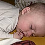 baby, bed, blanket, child, closeup, comfort, cozy, eyelashes, face, hand, indoors, infant, newborn, pajamas, peaceful, quiet, rest, skin, sleeping, soft