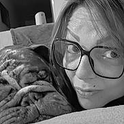 Baloo participe au concours pour gagner de l'argent avec cette photo : woman, dog, glasses, couch, indoor, snuggling, face, wrinkles, closeup, black_and_white, pet, companion, relaxing, cozy, portrait, home, comfort, expression, furniture, casual