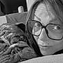 woman, dog, glasses, couch, indoor, snuggling, face, wrinkles, closeup, black_and_white, pet, companion, relaxing, cozy, portrait, home, comfort, expression, furniture, casual