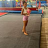 Blair joined the competition — help win amazing prizes! child, gymnast, gymnastics, indoor, sports, athlete, portrait, standing, pink_cup, drinking_cup, leotard, shorts, barefoot, gymnasium, mats, trampoline, equipment, climbing_wall, training, fitness