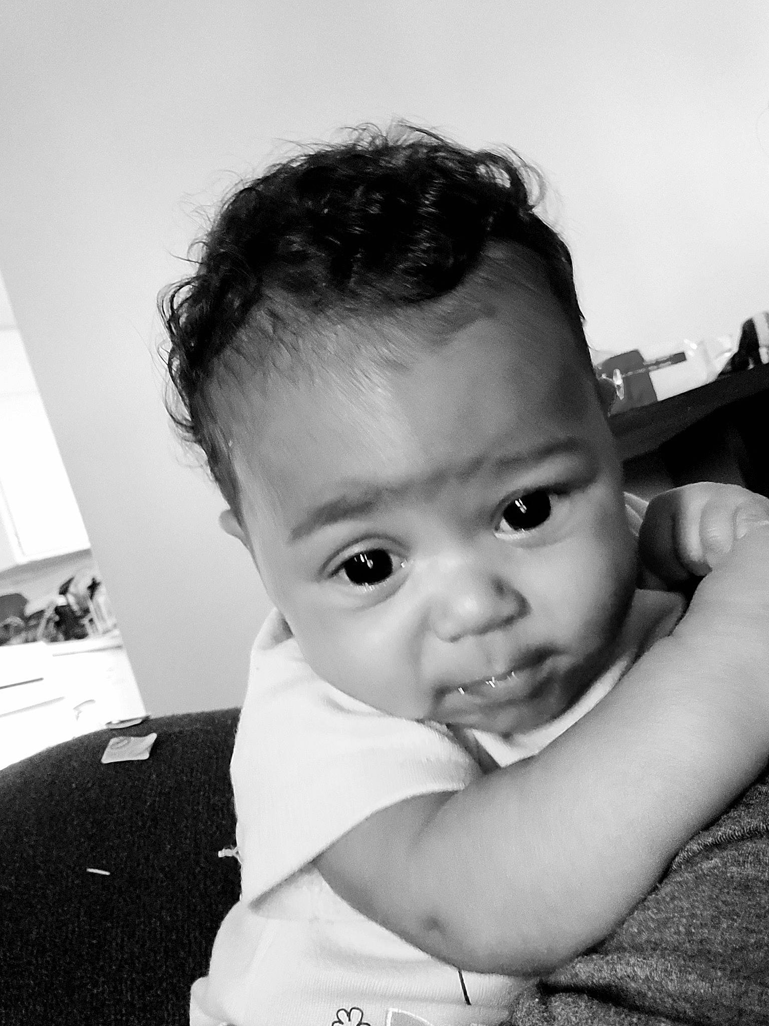 Makaylah is registered to the contest to win money with this photo: arm, baby, baby_toddler_clothing, black_and_white, cheek, child, eyelash, flash_photography, gesture, hand, happy, human_body, iris, lip, neck, nose, person, shoulder, skin, style