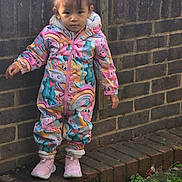 Araya joined the competition — help win amazing prizes! brick_wall, casual, child, colorful_clothing, cute, daylight, expression, fashion, grass, jumpsuit, outdoor, person, pigtails, pink_sneakers, plants, portrait, sidewalk, standing, toddler, young_child