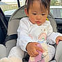 baby, car_interior, car_seat, child, clothing, curious, cute, duck_design, hand, indoors, person, pink_sunglasses, portrait, rainbow, seat, seatbelt, socks, toddler, white_shirt, window