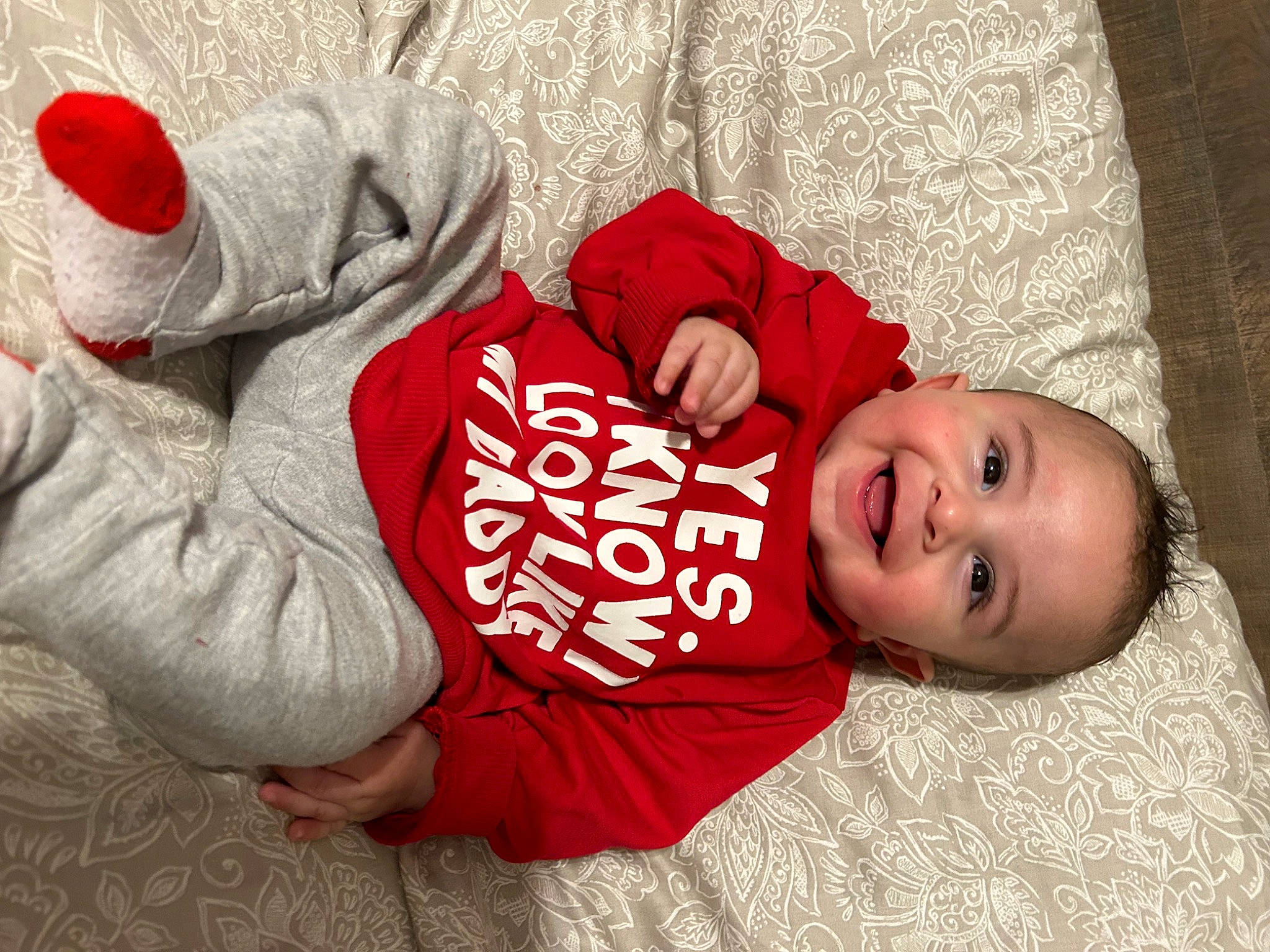 Malachi is registered to the contest to win money with this photo: arm, baby, baby_toddler_clothing, comfort, facial_expression, finger, hand, happy, head, headgear, human_body, joy, mammal, mouth, person, plant, skin, sleeve, smile, toddler