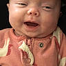 baby, infant, smiling, face, head, clothing, onesie, pink, animal_print, happy, cute, child, portrait, apparel, zipper, newborn, expression, human, closeup, cozy
