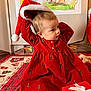 Mayana participe au concours pour gagner de l'argent avec cette photo : toddler, child, red_dress, christmas_trees, santa_hat, gift_box, holiday_decor, carpet, indoor, cute, festive, playful, portrait, young_child, floor, smiling, person, wall_art, holiday, seasonal