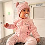 baby, pink, hat, pacifier, sitting, indoor, child, knit_hat, cozy, cute, granite_countertop, clothing, portrait, infant, soft_lighting, apparel, warm, young_child, face, expression