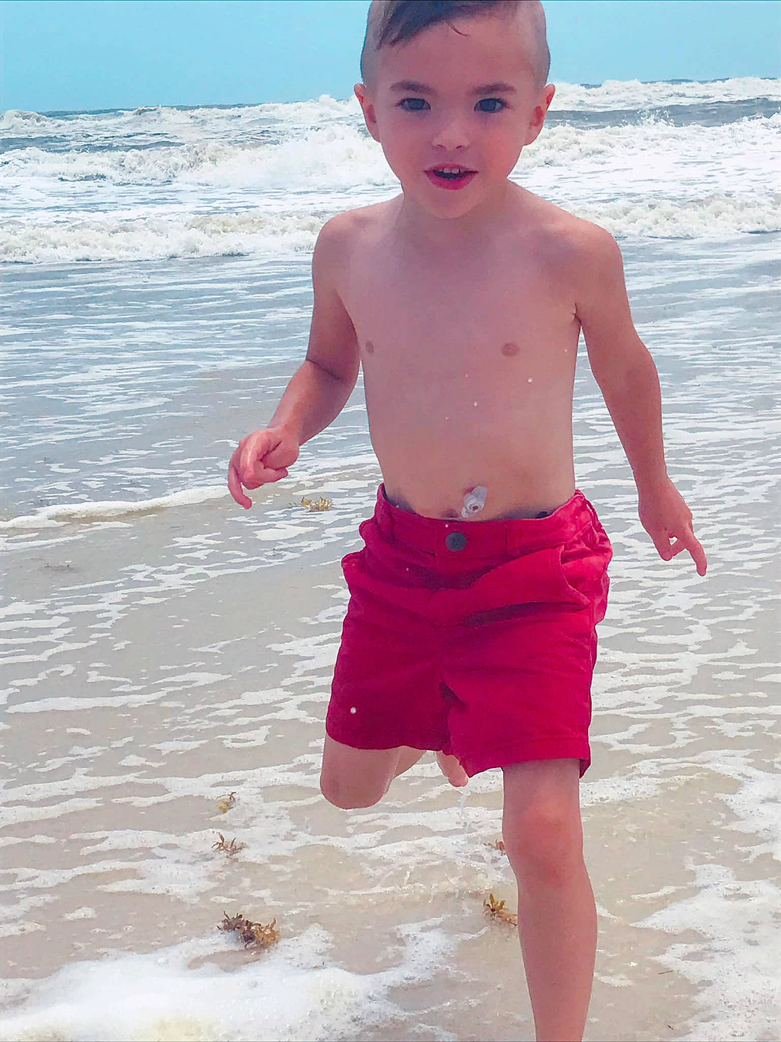 Brentley joined the competition — help win amazing prizes! barefoot, beach, board_short, child, fun, ocean, person, pink, play, sand, sea, shorts, smile, standing, summer, toddler, trunks, vacation, water, wave