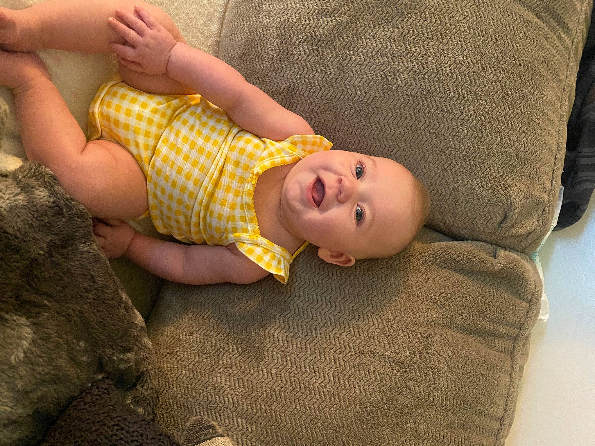 Madison is registered to the contest to win money with this photo: baby, baby_toddler_clothing, cheek, comfort, eye, finger, flash_photography, flooring, fun, hand, head, human_body, human_leg, knee, mouth, person, skin, smile, thigh, toddler
