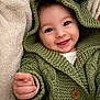 Elyo participe au concours pour gagner de l'argent avec cette photo : baby, blanket, button, child, closeup, cozy, cute, face, green_sweater, hand, happy, hoodie, indoors, infant, knitwear, person, portrait, smiling, soft, warm