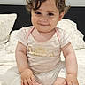 Ariel joined the competition — help win amazing prizes! baby, bed, bedding, bedroom, child, curly_hair, face, feet, hands, happy, indoors, infant, person, photography, pillow, pink_clothing, portrait, sitting, smiling, white_clothing
