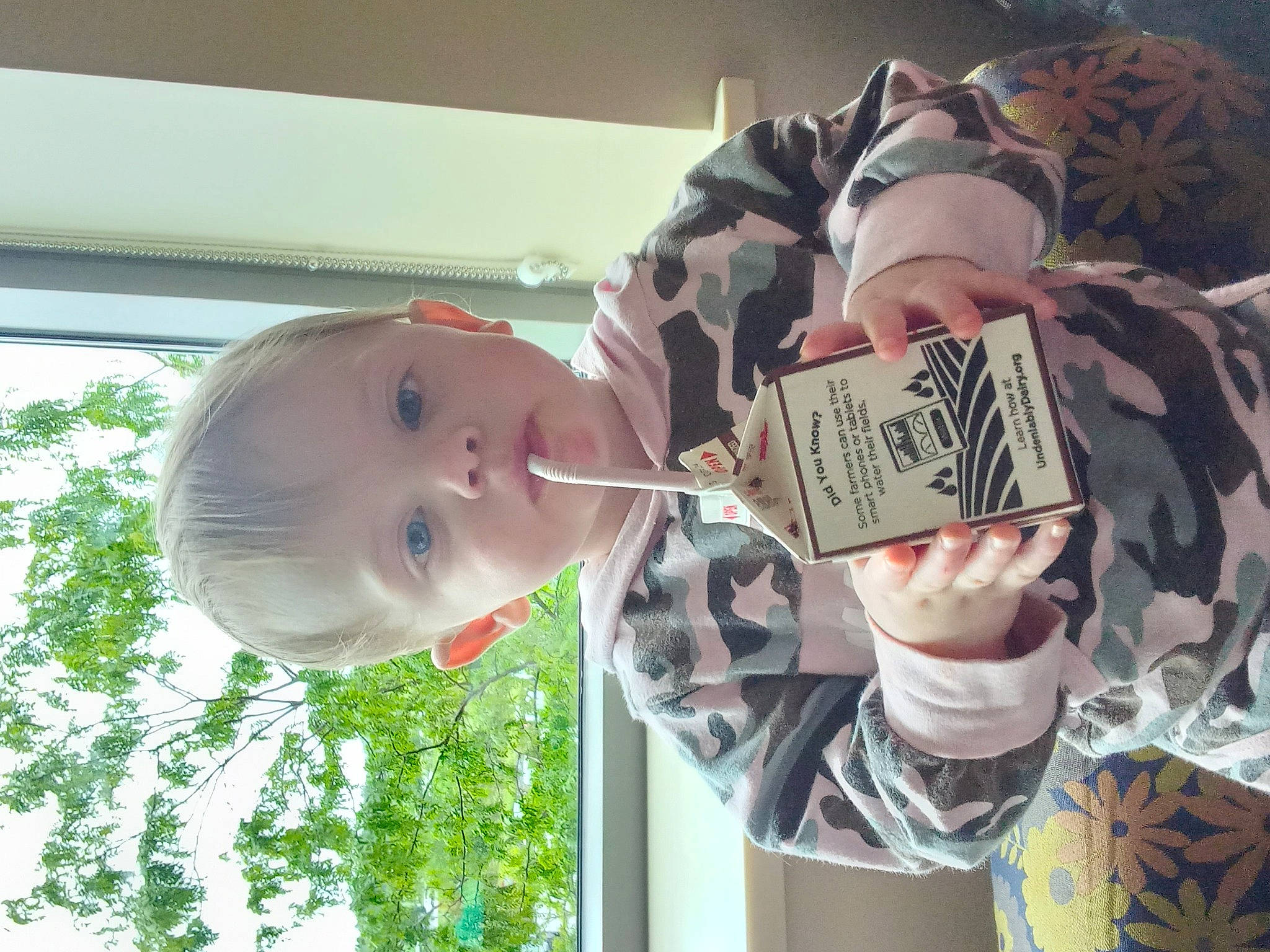 Lilly is registered to the contest to win money with this photo: baby, baby_products, baby_toddler_clothing, child, drinkware, eyelash, fashion_accessory, fun, happy, hat, pattern, person, toddler, water