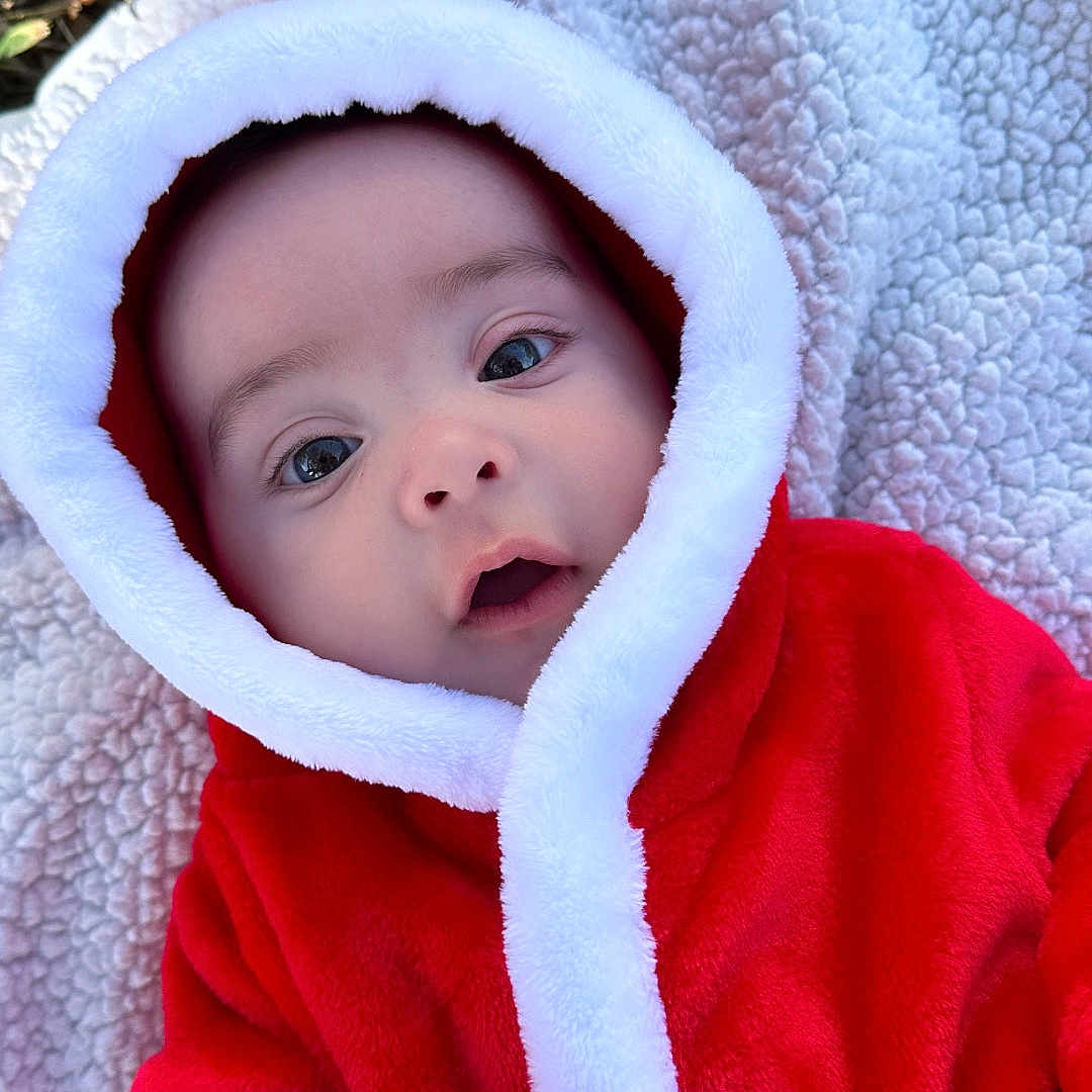 Adam joined the competition — help win amazing prizes! baby, blanket, bodypart, bonnet, clothing, coat, face, finger, hand, hat, head, hood, hoodie, jacket, knitwear, person, photography, portrait, sweater, sweatshirt