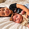 baby, child, siblings, brother, infant, smiling, happy, portrait, lying_down, bed, bedroom, blanket, headband, bow, clothing, family, toddler, newborn, indoors, closeup
