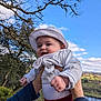 Olivia participe au concours pour gagner de l'argent avec cette photo : baby, infant, child, hat, hands, person, outdoors, sky, clouds, tree, branches, smile, happy, holding, river, hillside, landscape, nature, jacket, portrait