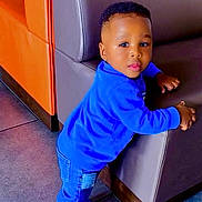 Hiram Treh participe au concours pour gagner de l'argent avec cette photo : toddler, child, blue_sweater, blue_jeans, blue_shoes, sneakers, indoor, couch, furniture, floor_tiles, curious, leaning, person, young_child, casual_clothing, portrait, happy, cute, home, baby