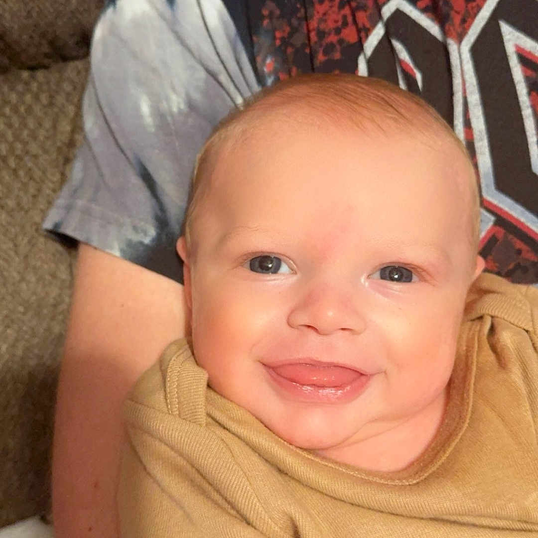 Gabriel is registered to the contest to win money with this photo: accessories, architecture, baby, blonde, bodypart, building, clothing, couch, cushion, earring, face, furniture, glasses, hair, happy, head, homedecor, indoors, jewelry, laughing