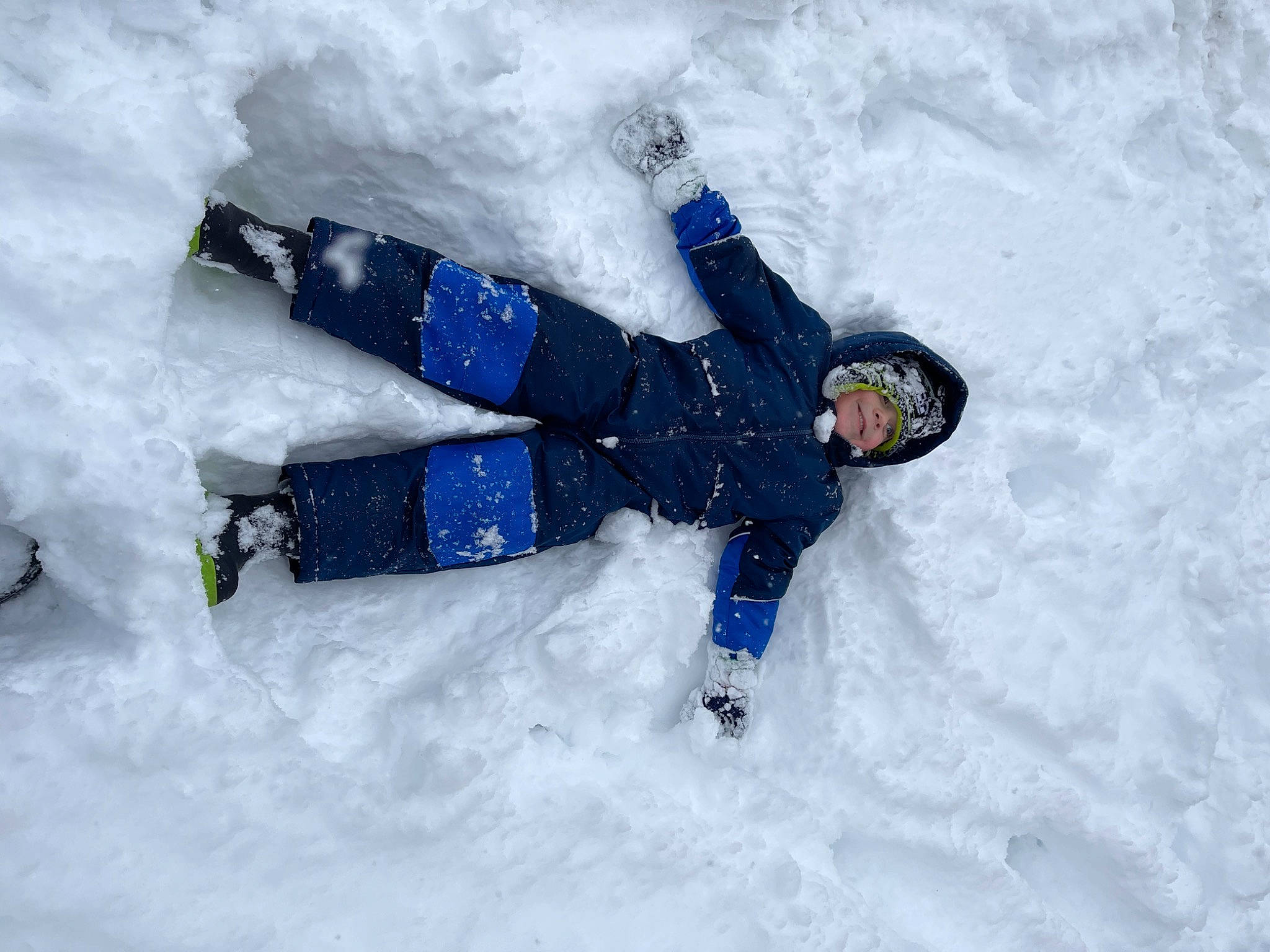 Deegan joined the competition — help win amazing prizes! adventure, electric_blue, freezing, fun, geological_phenomenon, glove, headwear, ice_cap, jacket, leisure, person, recreation, slope, smile, snow, snow_angel, tree, winter