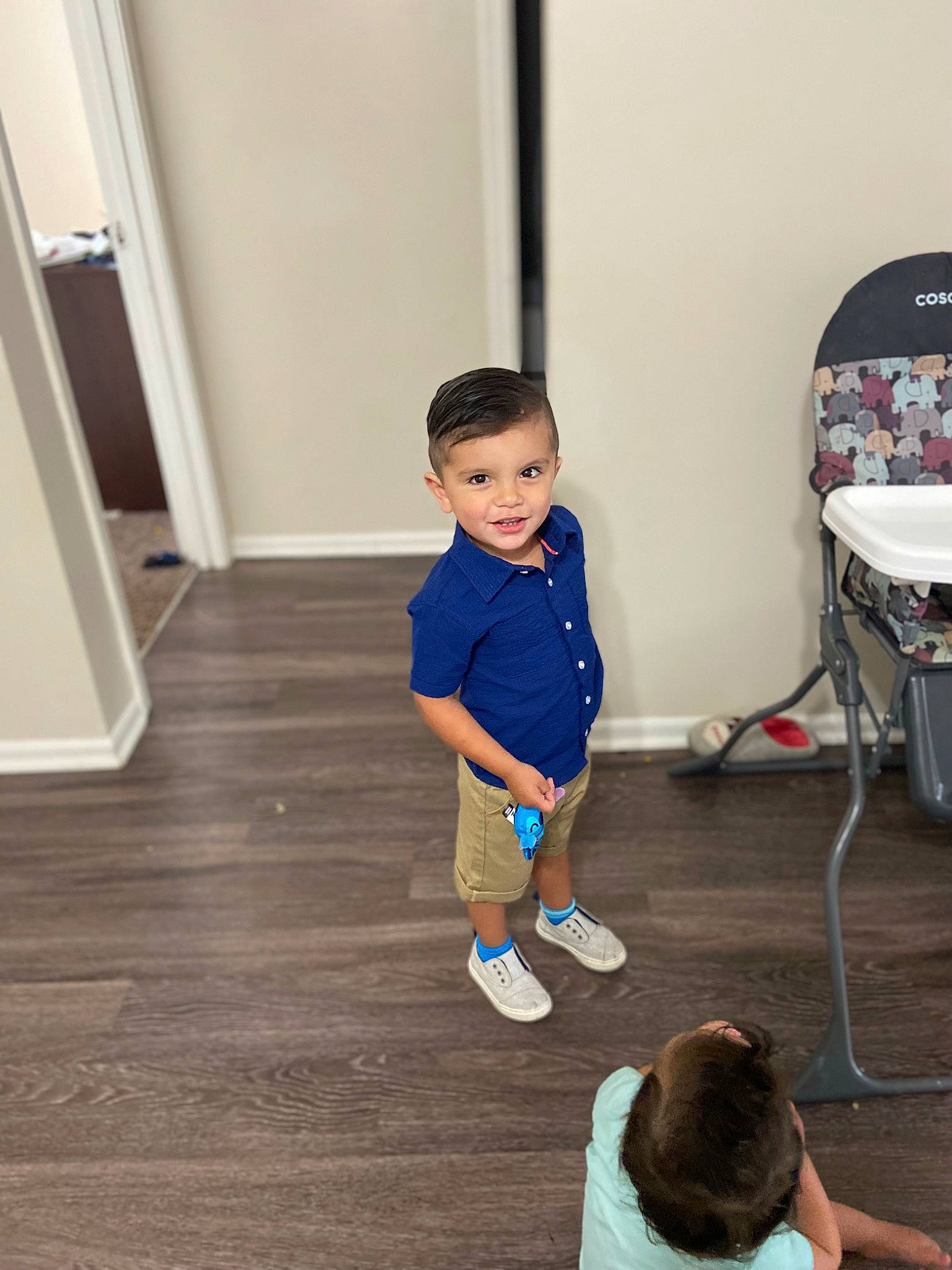 Dominik is registered to the contest to win money with this photo: baby_toddler_clothing, child, electric_blue, floor, flooring, fun, happy, hardwood, human_leg, joint, knee, laminate_flooring, leisure, person, shoulder, standing, t_shirt, thigh, toddler, wood