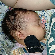 Cataleya joined the competition — help win amazing prizes! baby, sleeping, infant, portrait, face, pacifier, mitten, blanket, bedding, onesie, newborn, indoors, cozy, resting, side_profile, closed_eyes, dark_hair, floral_pattern, soft_lighting, nap