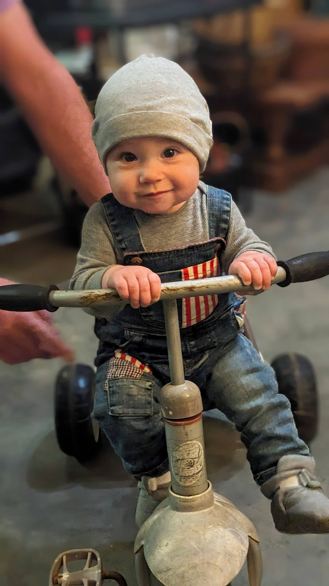 Kye is registered to the contest to win money with this photo: baby, baby_products, cap, child, face, fun, happy, headwear, human_leg, joy, musical_instrument, person, personal_protective_equipment, play, recreation, rolling, sitting, smile, tire, toddler