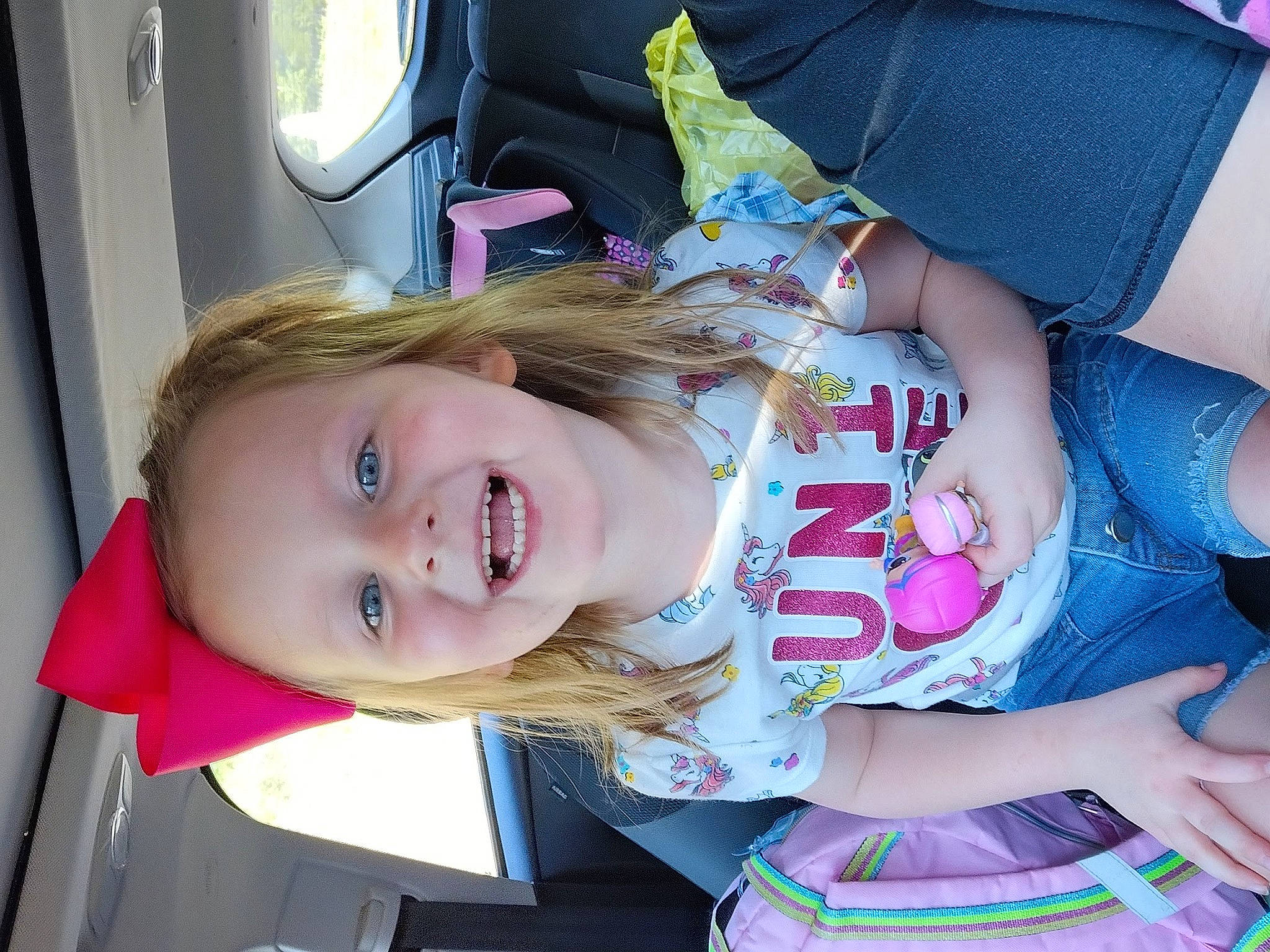 Liliana is registered to the contest to win money with this photo: auto_part, baby, baby_products, baby_toddler_clothing, blond, car, car_seat, cheek, child, face, fun, happy, joy, lip, mouth, nail, person, pink, skin, smile