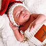 Cash is registered to the contest to win money with this photo: baby, newborn, sleeping, hat, knit_hat, red_hat, white_blanket, soft_texture, infant, cute, peaceful, resting, wrapped, cozy, portrait, christmas, holiday, child, warm, toddler