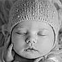 Nova joined the competition — help win amazing prizes! baby, sleeping, hat, knitted, beads, black_and_white, portrait, closeup, face, peaceful, cozy, infant, hand, soft, texture, newborn, cute, calm, resting, expression