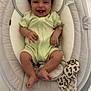 baby, smiling, infant, onesie, baby_rocker, soft_toy, floor, headrest, comfortable, happy, child, indoor, baby_clothing, baby_accessory, relaxing, cute, human, small_child, playtime, tiled_floor
