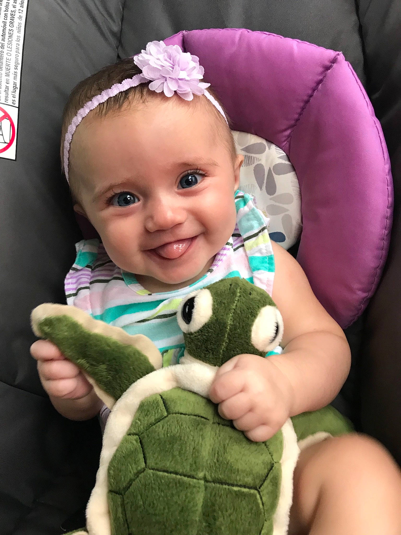 Reagan is registered to the contest to win money with this photo: arm, baby, baby_in_car_seat, car_seat, child, ear, eye, finger, hair_accessory, hand, head, joy, person, plush, stuffed_toy, thumb, toddler