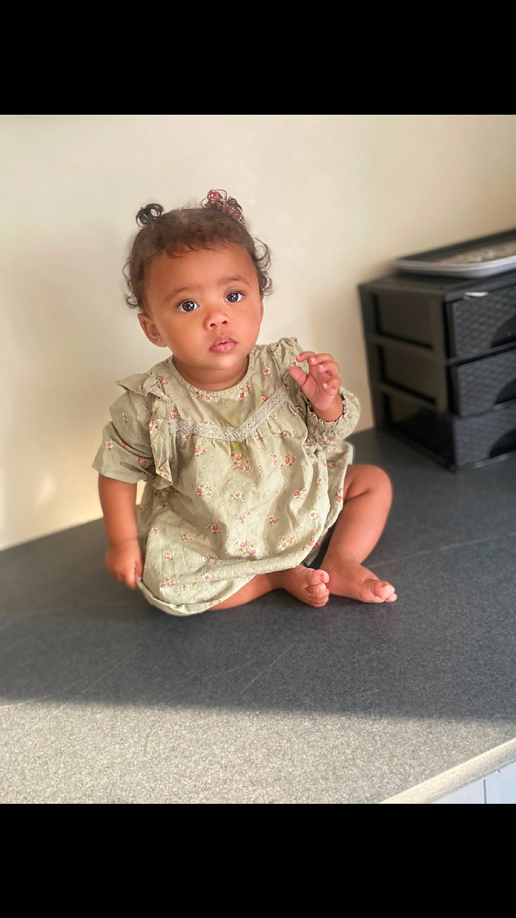 Alya participe au concours pour gagner de l'argent avec cette photo : baby, baby_toddler_clothing, cabinetry, cheek, chest_of_drawers, child, drawer, dress, flash_photography, floor, flooring, hair, happy, human_body, human_leg, person, room, sitting, sleeve, toddler