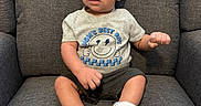 Kayson joined the competition — help win amazing prizes! baby, boy, child, infant, armchair, gray, clothing, shirt, shoes, face, expression, sitting, furniture, indoors, cute, portrait, person, feet, happy, small